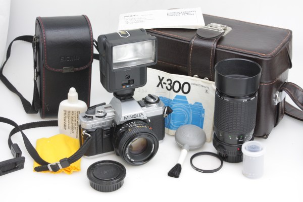 Minolta X-300 35mm SLR Camera, 50mm f/1.7, Sigma Zoom, Flash, Case & Strap