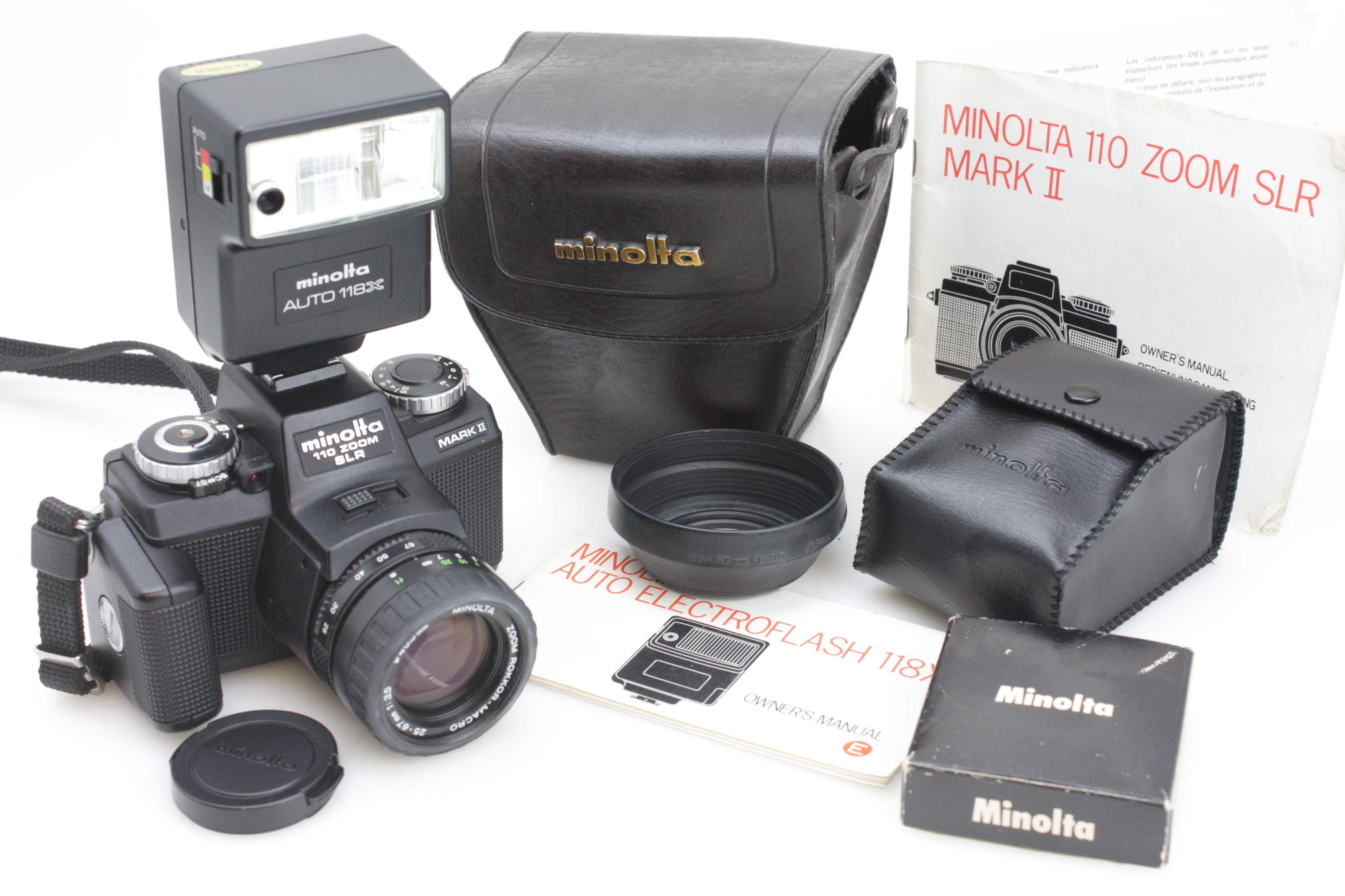 Minolta 110 Zoom SLR Mark II Camera 25-67mm f/3.5 Lens, Flash, Grip, Hood & Case